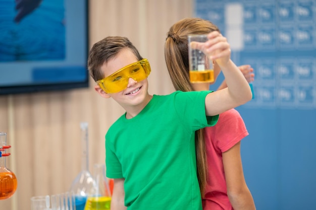 Junge mit Glas Rücken an Rücken mit Mädchen