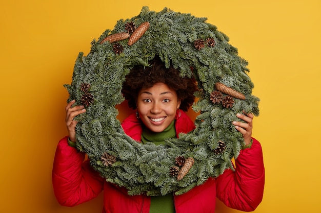 Junge schöne frau, die weihnachtsdekorationen hält