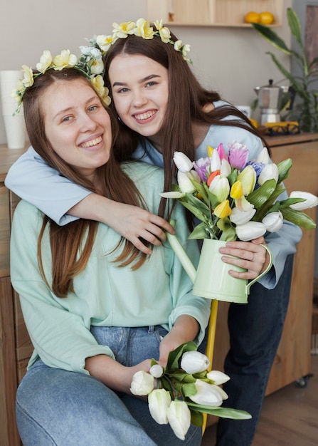 Kostenloses Foto junge schöne schwestern, die tulpenblumen halten