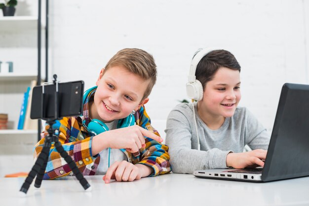 Jungen mit Laptop und Smartphone