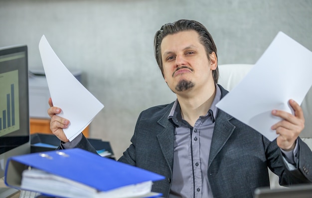 Junger Geschäftsmann, der von seinem Büro arbeitet