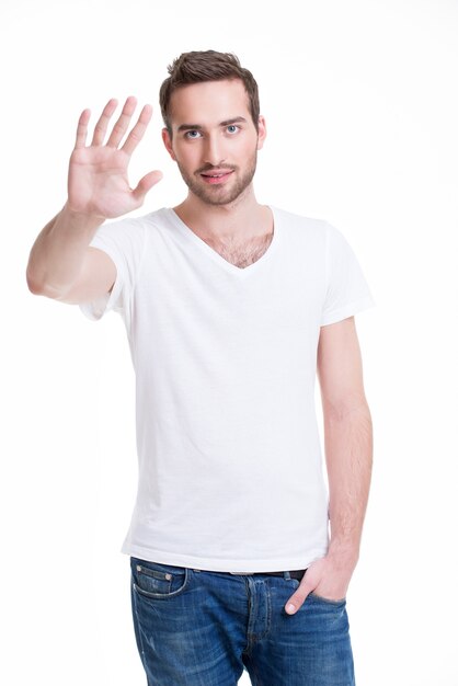 Junger gutaussehender Mann, der Halt mit seiner Hand benötigt - isoliert auf Weiß