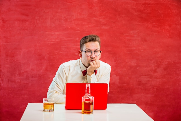 Junger lustiger mann mit laptop am valentinstag