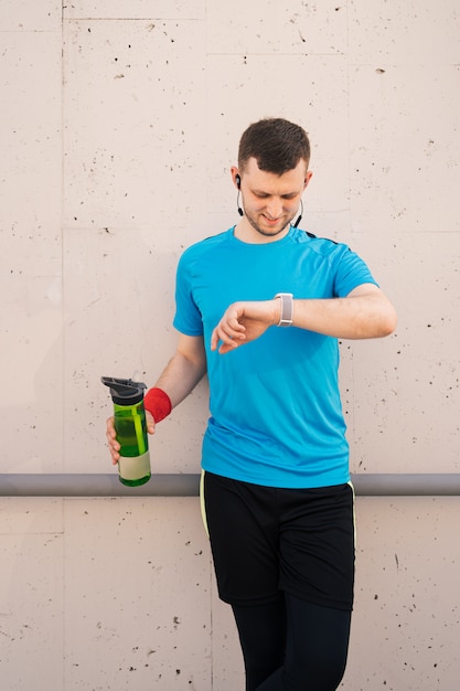 Junger Mann, der eine Pause macht - Fitnesskonzept in der Stadt.