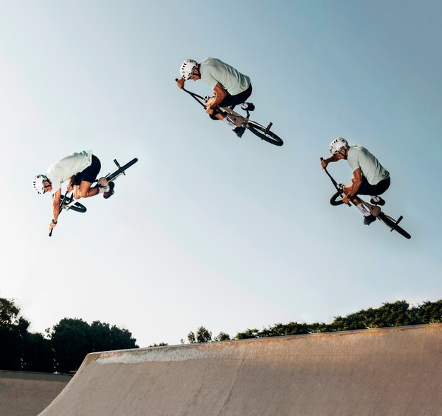 Junger Mann, der mit bmx Fahrrad am Rochenpark springt