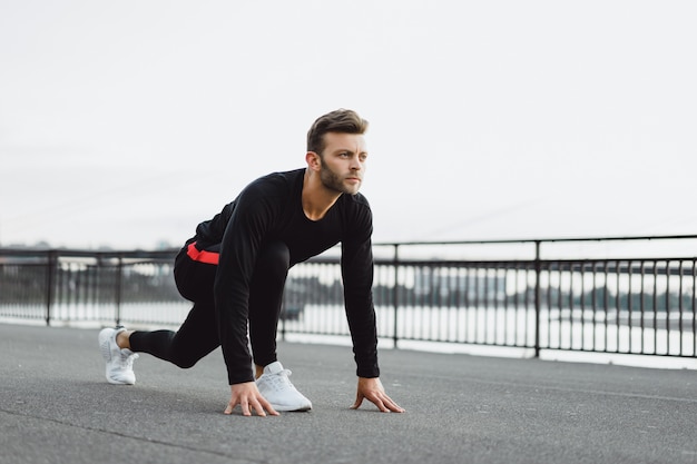 Junger Mann, der Sport in einer europäischen Stadt spielt. Sport in urbanen Umgebungen.