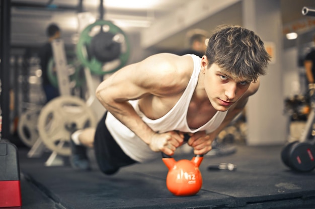 Kostenloses Foto junger mann trainiert im fitnessstudio