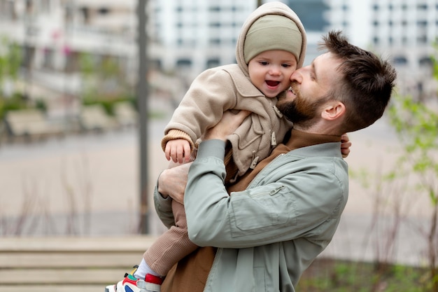 Kostenloses Foto junger vater mit seinem baby