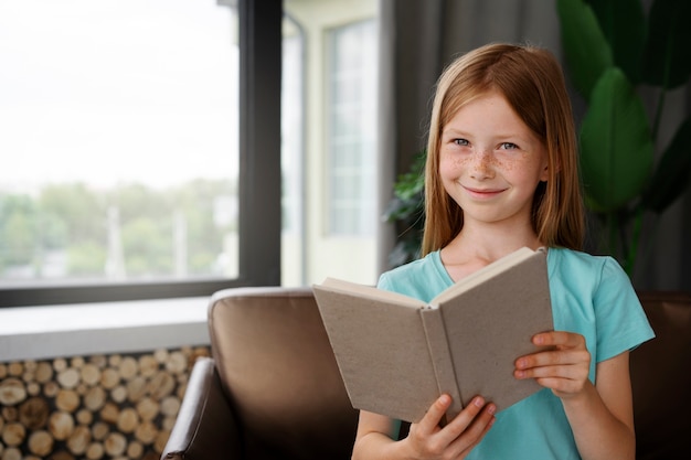 Kostenloses Foto junges mädchen ein buch zu lesen