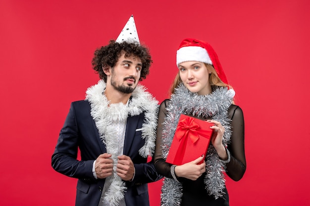 Junges paar der vorderansicht, das neues jahr auf weihnachtsliebefeiertag der roten wand feiert