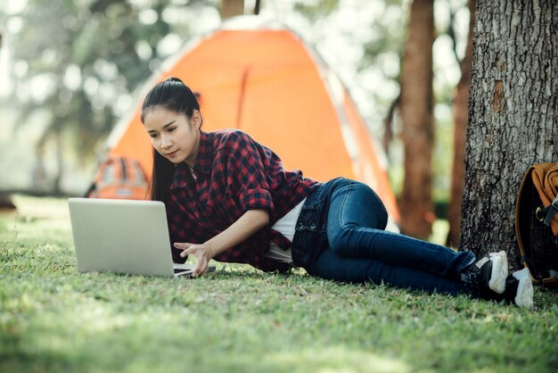 Junges schönes asiatisches Mädchen, das Laptop verwendet.