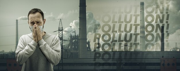 Kann nicht atmen. Mann mit Atemschutzmaske gegen Luftverschmutzung, Staubpartikel überschreiten die Sicherheitsgrenzen wegen rauchender Fabriken.