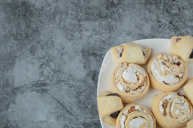 Kaukasische traditionelle Kekse mit Zuckerpulver oben auf weißer Keramikplatte.