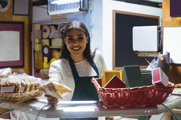 Kellnerin gibt Paket an der Theke im Café