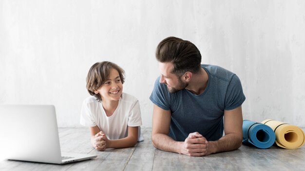 Kid und sein Vater treiben zu Hause Sport