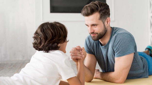 Kid und sein Vater treiben zu Hause Sport