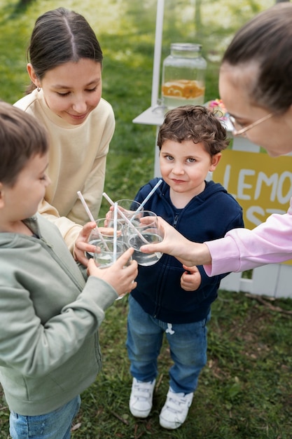 Kostenloses Foto kinder des hohen winkels, die limonade halten