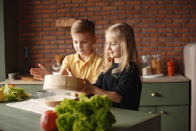 Kinder spielen mit einem Mehl in einer Küche