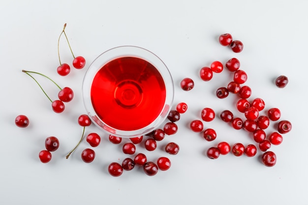 Kirschsaft in einem Glas mit Kirschen Draufsicht auf einem Weiß