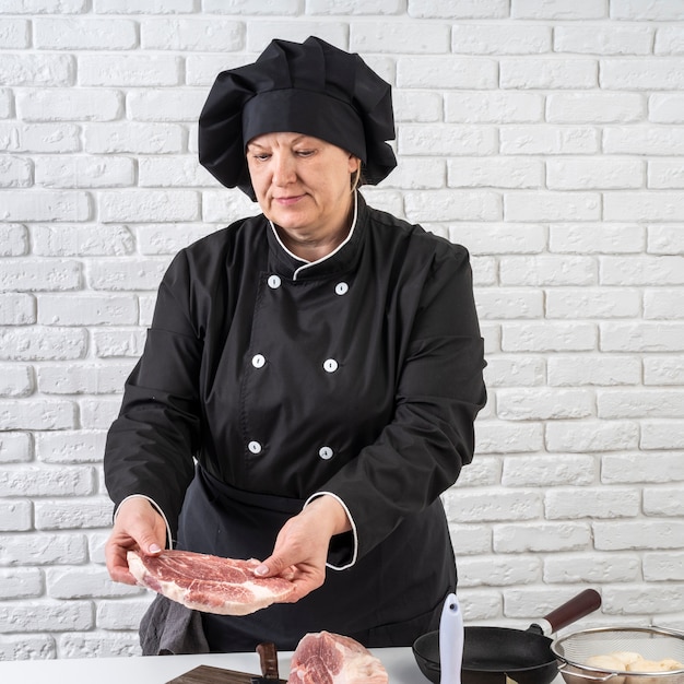 Kostenloses Foto köchin, die fleisch vorbereitet