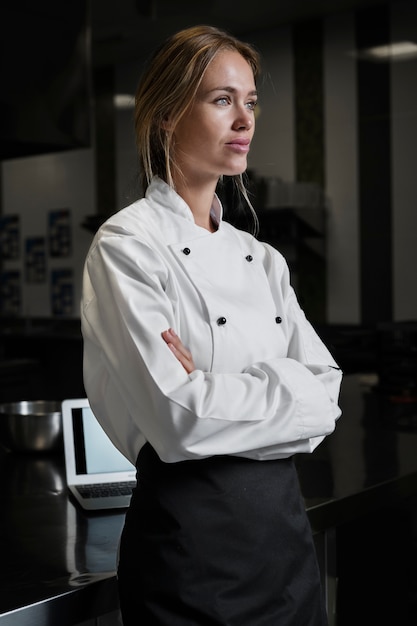 Kostenloses Foto köchin in der küche in schürze und uniform gekleidet