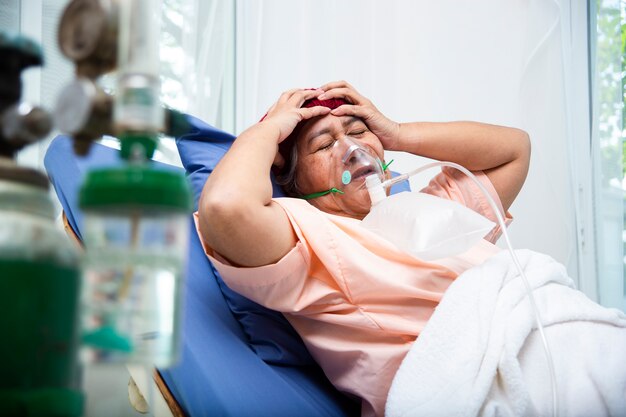 Kopfschmerz der asiatischen älteren Fraupatienten im Krankenhaus