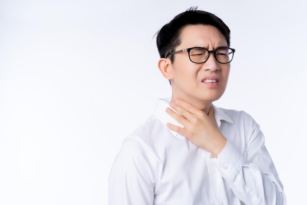 Kranke asiatische Brille männliche Erwachsene Halsschmerzen Hand berühren Hals mit stressigen und angespannten weißen Hintergrund-Gesundheitsideen-Konzept