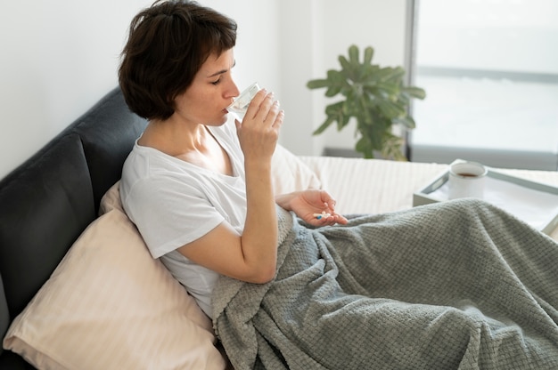 Kranke Frau mit mittlerem Schuss im Bett