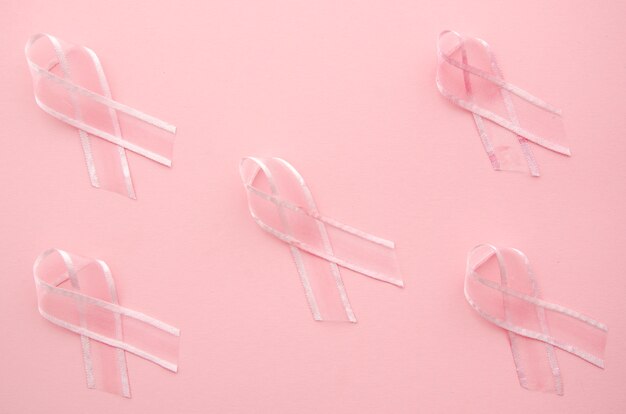 Krebsbewusstsein mit Bändern auf rosa Hintergrund