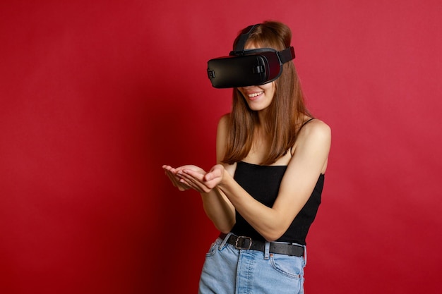 Lächelnde Dame, die eine VR-Brille trägt und ihre Hände zusammenhält