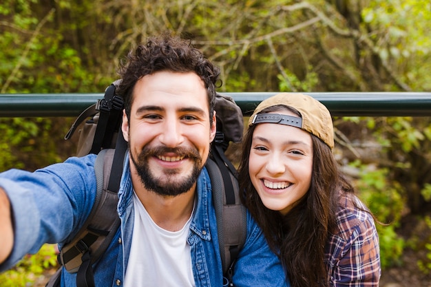 Lächelnde Paare, die selfie während der Reise nehmen