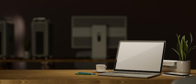 Laptop-computer-bürobedarf und mock-up-platz auf dem tisch über dunklem büro in der nacht 3d-rendering
