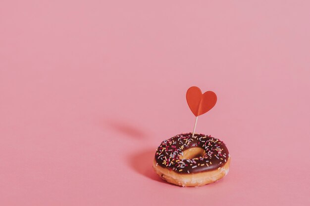 Leckerer glasierter Donut mit Herz verziert