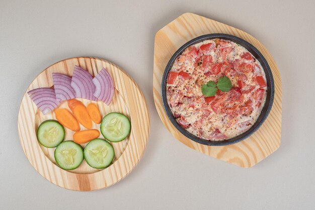 Leckeres Essen mit geschnittenem Gemüse auf Holzbrett.