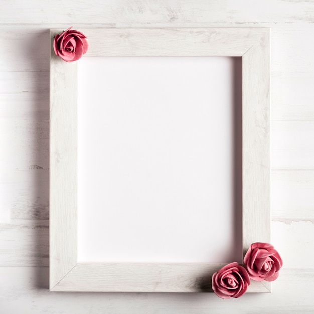 Kostenloses Foto leerer holzrahmen mit schönen rosen