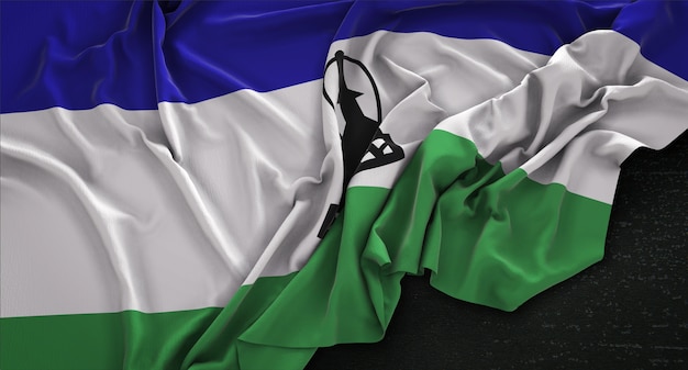 Kostenloses Foto lesotho-flagge, die auf dunklem hintergrund verstreut ist 3d render