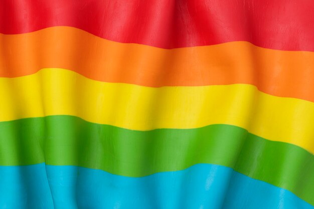 LGBTQ+ Regenbogenflaggenhintergrund in DIY Plastilin-Ton-Textur