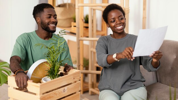 Liebespaar auf dem Sofa, das einen Plan macht, Haus neu zu dekorieren