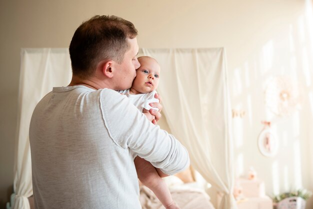 Liebevoller mittlerer Schuss des Vaters und des Babys