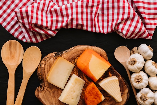 Löffel und Serviette nahe Käse und Knoblauch