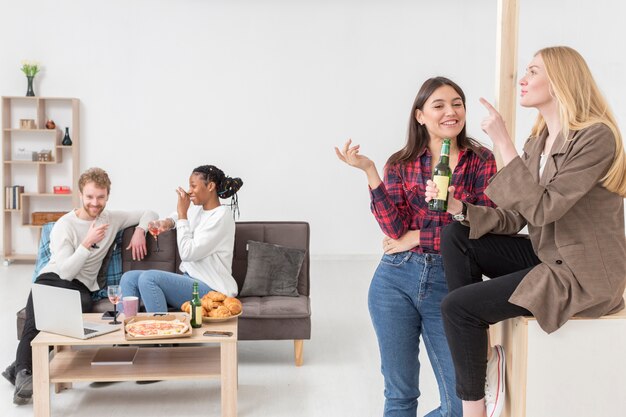 Low Angle Freunde zu Hause genießen das Mittagessen