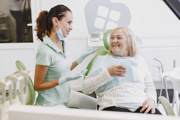 Ältere Frau, die Zahnbehandlung in der Zahnarztpraxis hat. Frau wird wegen Zähnen behandelt