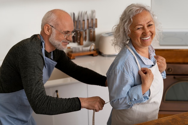 Ältere Paare, die zusammen in der Küche kochen