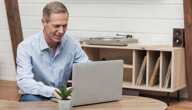 Älterer Mann, der durch das Internet schaut