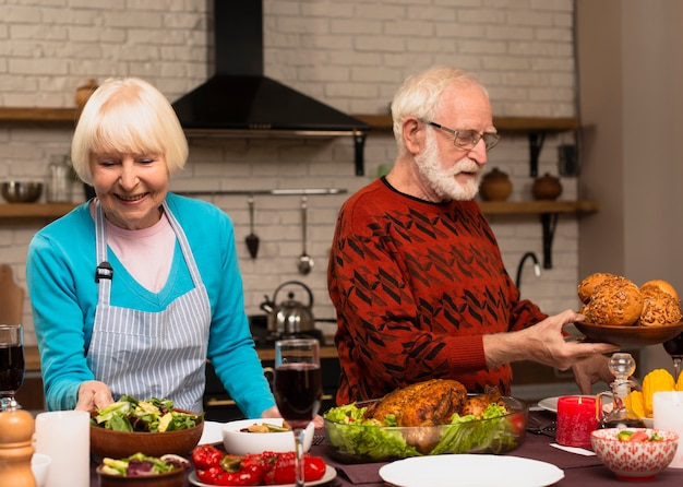 Älteres verheiratetes Paar, welches die Erntedankmahlzeit vorbereitet