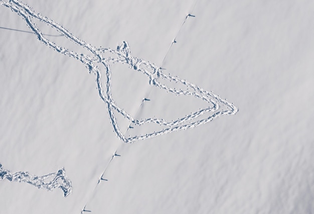 Luftaufnahme der Fußabdrücke auf dem Schnee im Winter