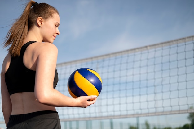 Kostenloses Foto mädchen, das mit volleyball aufwirft