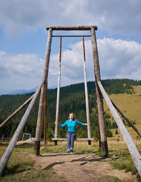 Mädchen, das schöne Zeit auf der riesigen Schaukel hat