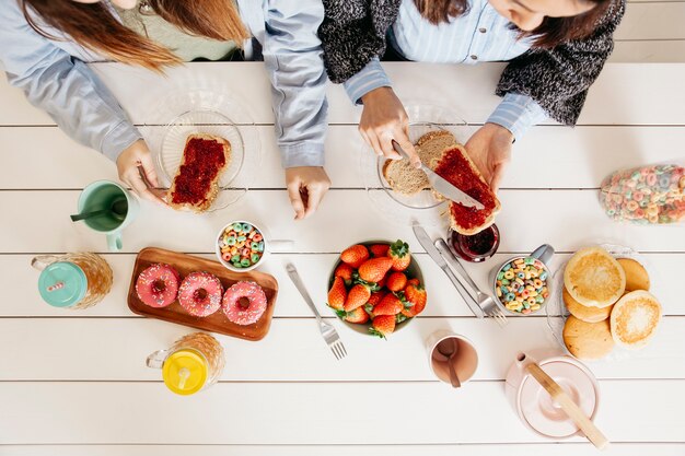 Mädchen, die süße bunte Mahlzeit genießen