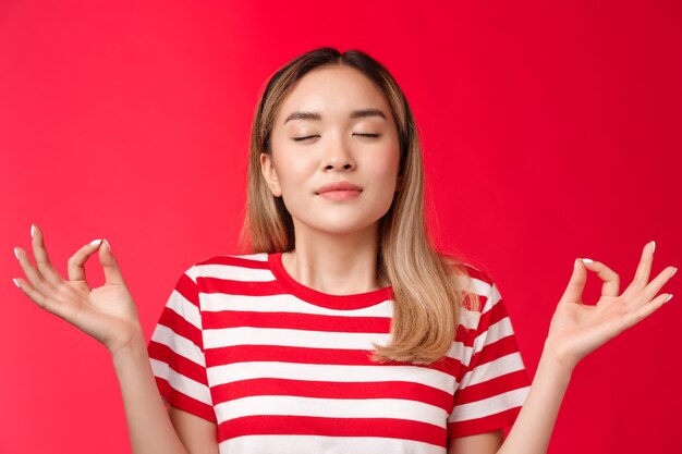 Mädchen fühlen zen süßes asiatisches mädchen, das meditiert, vereinen sich mit der natur enge augen atmen tief halten hände r ...